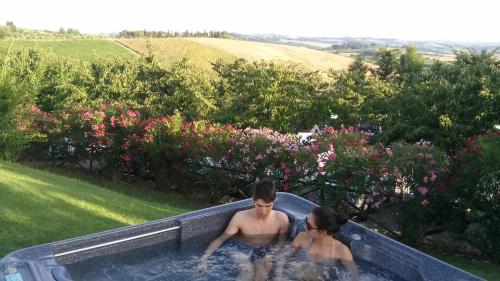 a man and a woman in a bath tub at Hotel Belvedere Di San Leonino in Castellina in Chianti