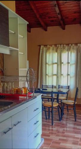 a kitchen with a table and a table and chairs at La Posta de Gherard in Maimará