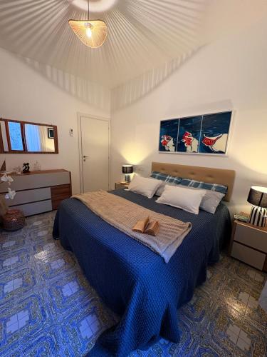 a bedroom with a large bed with a blue blanket at Crueza de ma in Bonassola