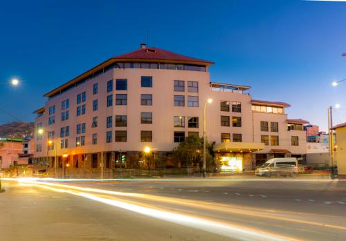 a building on a city street at night with light trails at Hotel Jose Antonio Cusco in Cusco