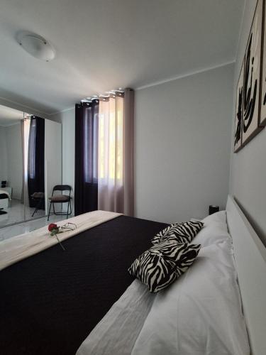 a bedroom with a large bed with a pillow on it at Stornelli Suite & Apartments in Avezzano