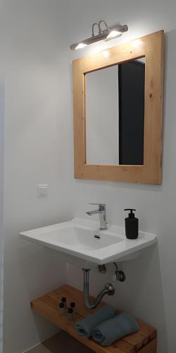 a bathroom with a white sink and a mirror at Maria's Private Space - Mykonos in Ano Mera