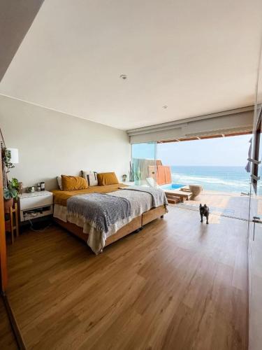 a bedroom with a large bed with a view of the ocean at Oceanview 2BR with Terrace in Punta Hermosa in Punta Hermosa