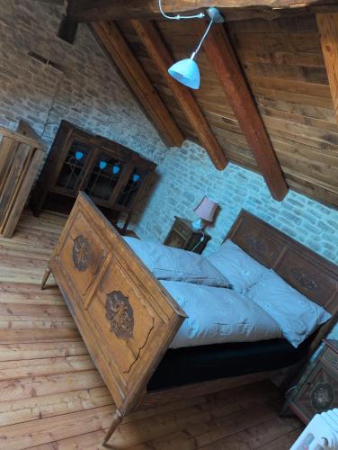 a bedroom with a bed with a wooden frame at Casa Vacanza in Serravalle delle Langhe