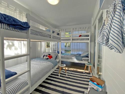 a room with two bunk beds and a desk at Sandy Shores in Amity Point