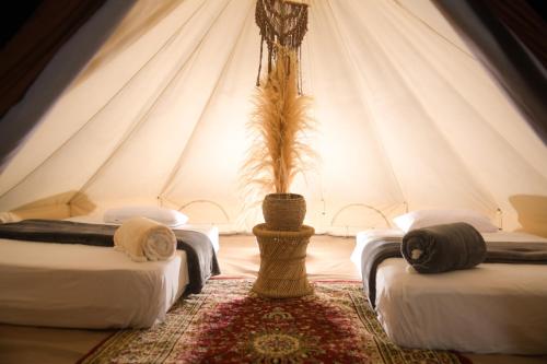 a room with two beds in a tent at Duna Camp Huacachina in Ica