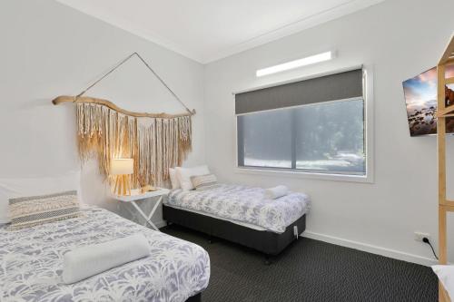 a bedroom with two beds and a window at Salty Beach in Amity Point