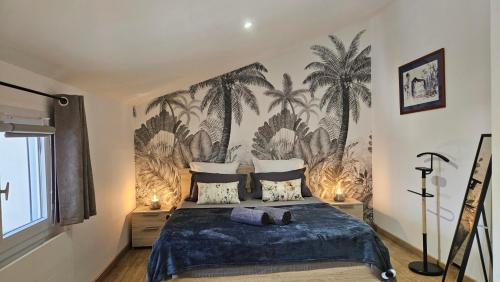 a bedroom with a bed with a palm tree mural at GITE familiale avec piscine in Saint-Martin-de-la-Coudre