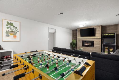 a living room with a large foosball table at Poolside Paradise with Hot Tub in Boise