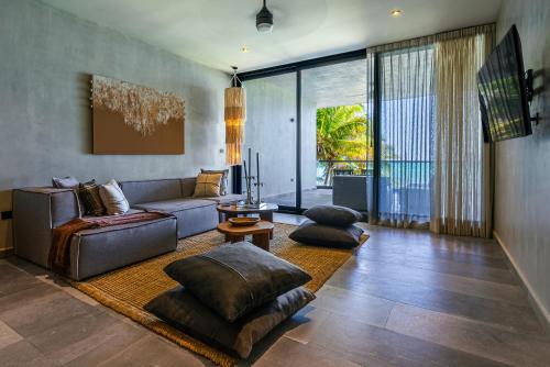 a living room with a couch and a table at Luxury Beachfront 3BR Apt 102 | Neea Bahia Soliman in Balcheil