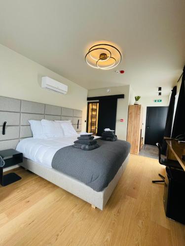 a bedroom with a large bed and a television at Hotel Mezza Notte in Ronse