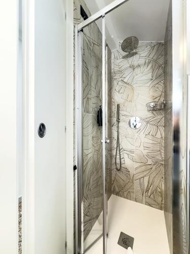 a shower with a glass door in a bathroom at Hotel Caffaro in Genoa