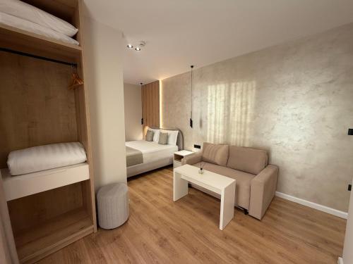 a small room with a couch and a bed at Velour Boutique Hotel Durres in Durrës