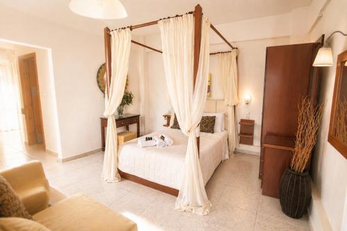 a bedroom with a bed with a canopy at Assamaris in Asprovalta