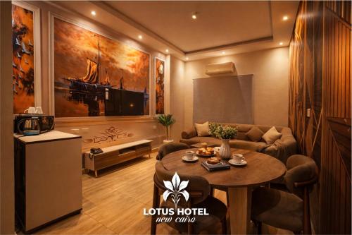 a living room with a couch and a table at Lotus Hotel - Golden Square in Cairo