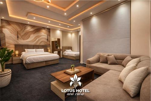 a hotel room with a couch and a bed at Lotus Hotel - Golden Square in Cairo