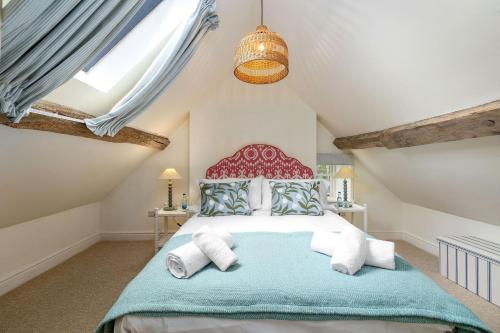 a bedroom with a large bed in a attic at Fernhalls Mill in Munslow
