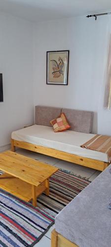 a room with two beds and a table at Dar Mnasri in Houmt Souk