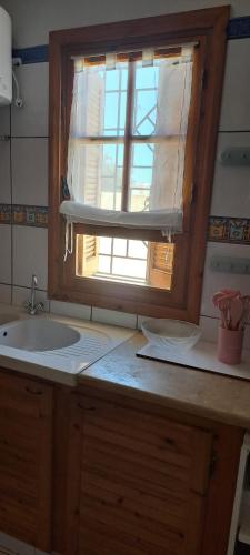 a kitchen with a sink and a window at Dar Mnasri in Houmt Souk