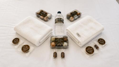 a group of different types of candies and a bottle at Refúgio Casinha Branca in Duque de Caxias