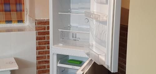 an empty refrigerator with its door open in a kitchen at Berci Villa in Balatonboglár