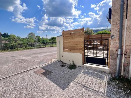 a building with a gate on the side of a road at La Terrasse de Mâlain in Mâlain