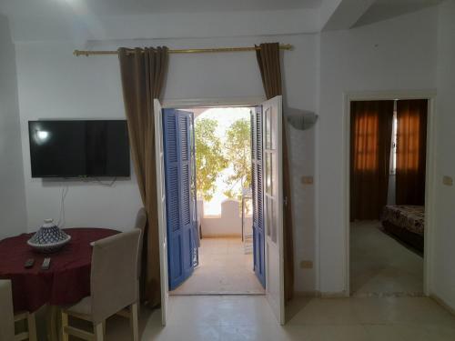a room with a door open to a room with a table at Taguermess Tag 1 in Midoun