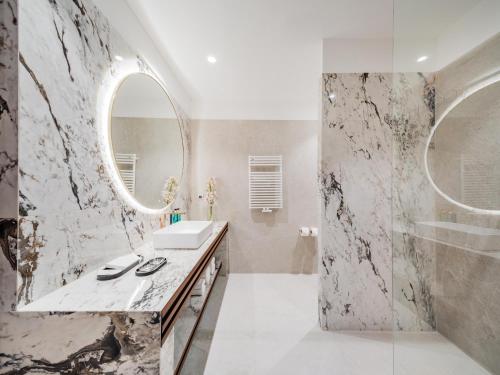 a bathroom with a sink and a mirror at Diaco Boutique Hotel in Đakovo