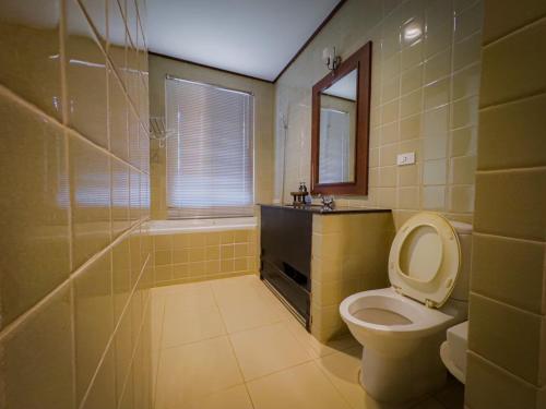 a bathroom with a toilet and a sink and a tub at Kooncharaburi Resort - Koh Chang in Ko Chang