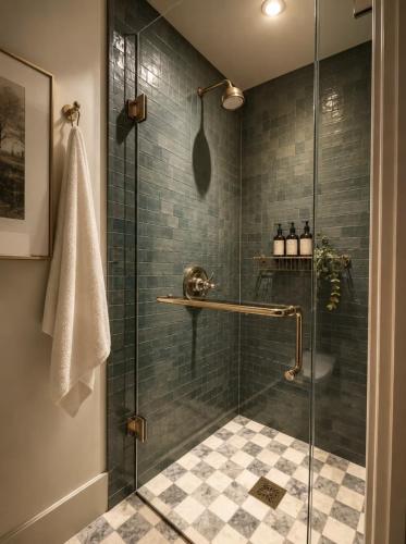 a bathroom with a shower with a glass door at Simpson House Inn in Santa Barbara
