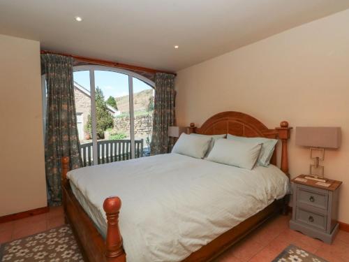 a bedroom with a bed and a large window at Pearls Farm Two in Macclesfield