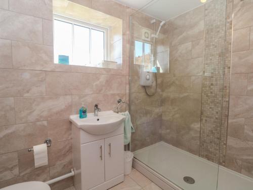a bathroom with a sink and a toilet and a shower at Pearls Farm Two in Macclesfield