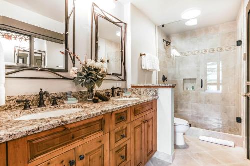 a bathroom with a sink and a toilet and a mirror at 104 Highlands Westview in Avon