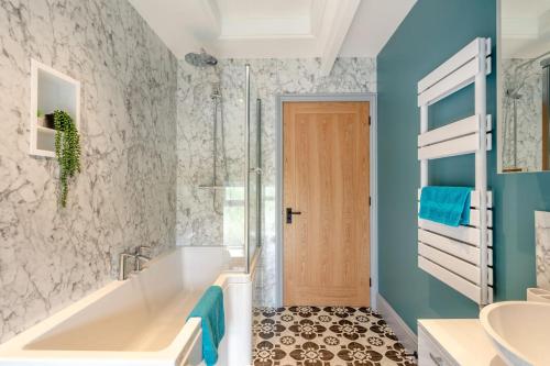 a bathroom with a tub and a sink at 6 Bed in Holsworthy oc-s41430 in Merryfield