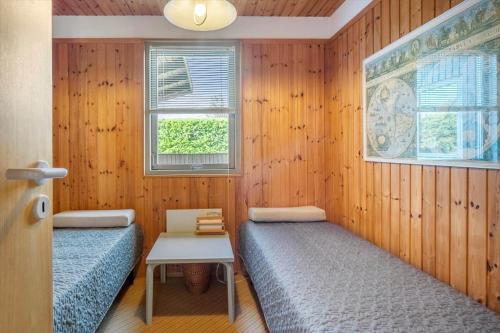 a room with two beds and a table in it at FY418-Faaborg-Fruerlund-48 in Faaborg