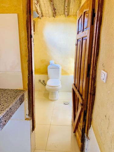 a bathroom with a toilet in a room at Fayoum Desert Camp in Qaryat Ḩātim aţ Ţāʼī