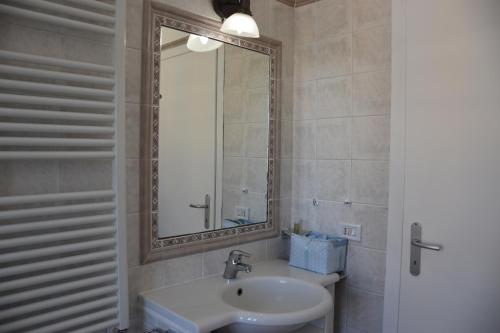 a bathroom with a sink and a mirror at LightHouse - Surfandwindsurferhouse in Anzio