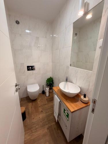 a bathroom with a sink and a toilet and a mirror at A Janela do Cantinho in Reguengos de Monsaraz