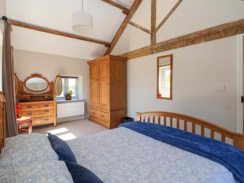 a bedroom with a blue bed and a dresser at The Granary in York
