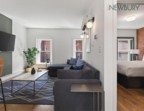 a living room with a couch and a bed at 304 Newbury Street by Thatch in Boston