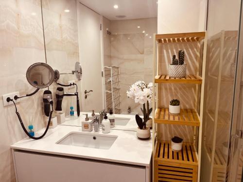 a bathroom with a sink and a shower at Sonho de Sesimbra in Sesimbra