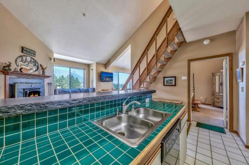 a kitchen with a sink and green tiled counter top at Kirkwood Mountain Resort by Vail Resorts in Kirkwood