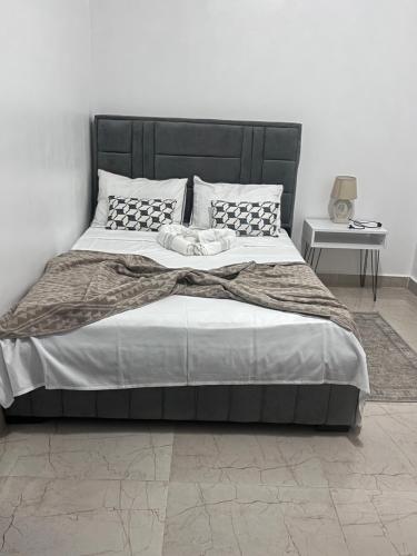 a bedroom with a large bed with a black headboard at Condominio hortencia in Viana