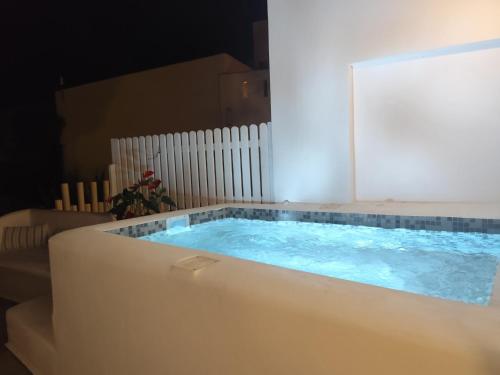 a large tub with blue water in a room at Filippa Studios in Plaka