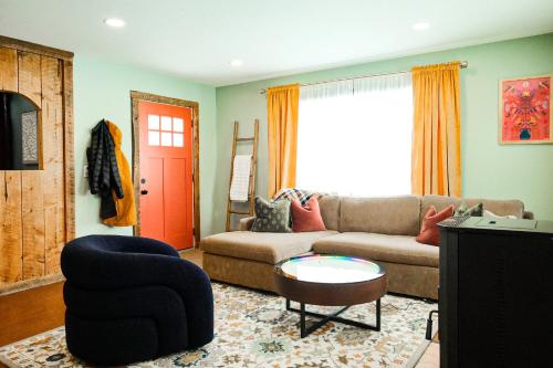 a living room with a couch and a table at Family Fun Indoor Play Zone UP Waterfalls in Bessemer