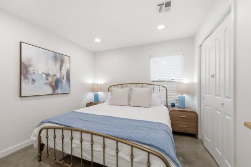 a bedroom with a bed and a painting on the wall at Decantur Inn 3 King Bedrooms in Lafayette