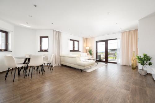a living room with a white couch and a table at Dům Pavlov in Pavlov