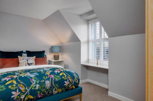 a bedroom with a bed and a window at Pear Tree Cottage, Dunblane in Dunblane