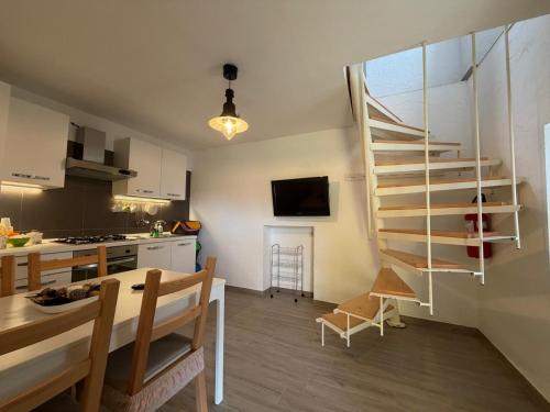 eine Küche und ein Esszimmer mit Wendeltreppe in einer Wohnung in der Unterkunft MH Vicende in San Massimo