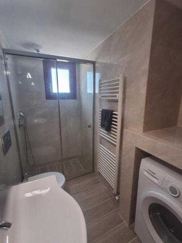 a bathroom with a shower and a toilet and a sink at Manolas Sunset View in Glinádhon
